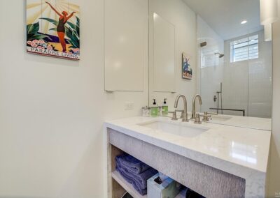 Modern bathroom interior with double sink vanity and decorative artwork on the wall.