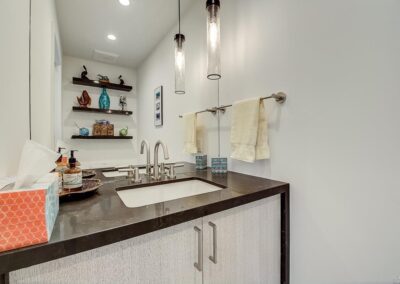 Modern bathroom interior with a double sink vanity and pendant lights.